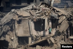 Seorang anggota pertahanan sipil berdiri di tengah kerusakan setelah apa yang menurut sumber keamanan merupakan serangan Israel di sebuah pasar, di Nabatieh, Lebanon selatan, 13 Oktober 2024. (Foto: Reuters)