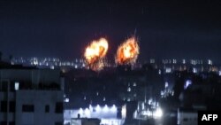 Ledakan menerangi langit malam di Kota Gaza saat pasukan Israel menembaki daerah Palestina.