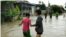 Girls stand in a flooded area of Prek Chrey village, Spean Tmor commune, Dangkoa district, Phnom Penh, Cambodia, on Oct. 15, 2020. (Malis Tum/VOA Khmer)