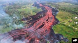 FILE - In this May 19, 2018, photo released by the U.S. Geological Survey, lava flows from fissures near Pahoa, Hawaii. 