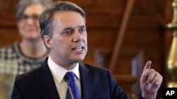 FILE - Kansas Gov. Jeff Colyer speaks to a joint session of the Kansas Legislature at the Statehouse in Topeka, Kan., Feb. 7, 2018.
