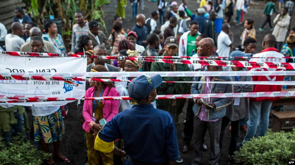 Witnesses and voters wait for the Katendere voting center to open in Goma, Dec. 30, 2018. Voters in the Democratic Republic of Congo went to the polls Sunday in elections that will shape the future of their vast, troubled country.