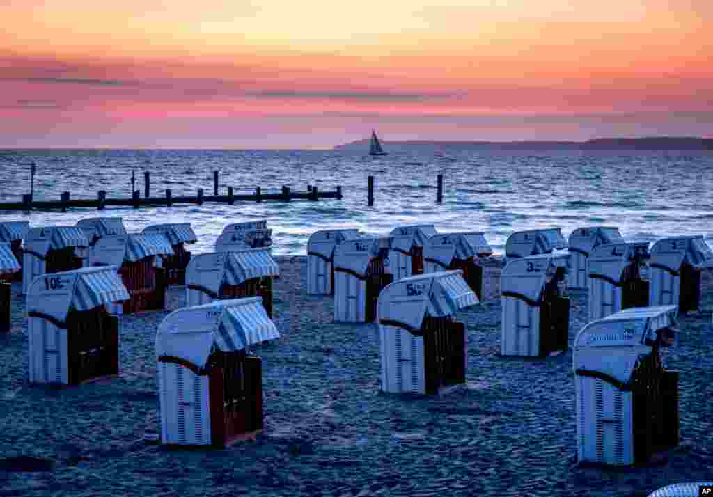 Beach chairs are lined up at the Baltic Sea before sunrise in Travemuende, northern Germany.