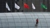 A worker descends on the rooftop of a building at the central business district in Beijing, China, July 15, 2024. China's Communist Party is starting a meeting Monday expected to lay out a strategy for self-sufficient economic growth.