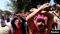 Women supporters show the Oromo protest gesture outside Jawar Mohammed's house, an Oromo activist and leader of the Oromo protest in Addis Ababa, Ethiopia, Oct. 23, 2019.