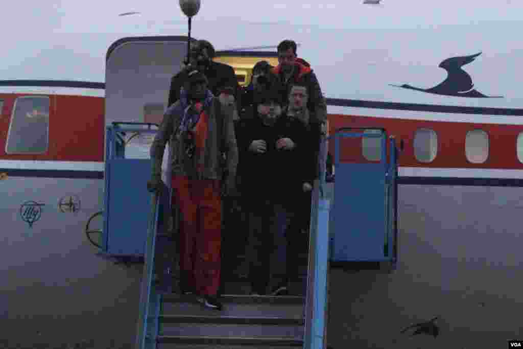 Dennis Rodman disembarks from a flight from Beijing as he and his entourage arrive at the international airport in Pyongyang, Dec. 19, 2013.&nbsp;