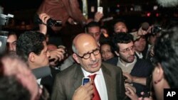 Mohamed ElBaradei talks to members of the media as he arrives at Cairo's airport in Egypt, Jan. 27, 2011