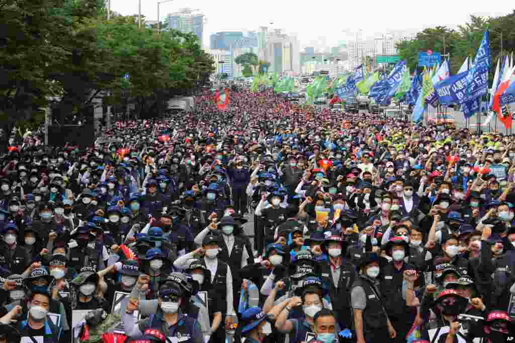 Workers wearing face masks to help protect against the spread of the new coronavirus stage a rally against the government&#39;s labor policy, in Seoul, South Korea.