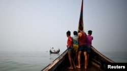 FILE - Rohingya refugees crew a fishing boat in the Bay of Bengal near Cox's Bazar, Bangladesh, March 24, 2018. 