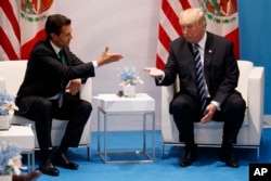 FILE - President Donald Trump meets with Mexican President Enrique Pena Nieto at the G20 Summit, July 7, 2017, in Hamburg.