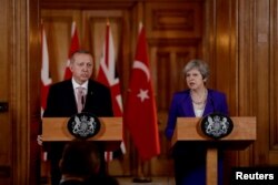 Turkey's President Recep Tayyip Erdogan and British Prime Minister Theresa May take part in a news conference after their meeting at 10 Downing Street in London, Britain, May 15, 2018.
