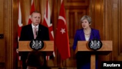 Turkey's President Recep Tayyip Erdogan and British Prime Minister Theresa May take part in a news conference after their meeting at 10 Downing Street in London, Britain, May 15, 2018.