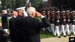 Vice President Mike Pence, right, salutes during a ceremony honoring 241 U.S. Service members killed 34 years ago in the 1983 bombing of the Marine Barracks in Beirut, Lebanon, Oct. 23, 2017 at the Marine Barracks in Washington. 