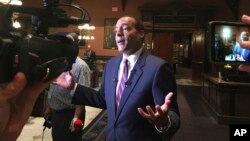 Michael B. Moore talks to reporters, Sept. 20, 2017, at the Statehouse in Columbia, S.C., about a proposal to honor his great-great grandfather Robert Smalls with a monument on grounds outside.