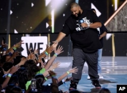 FILE - DJ Khaled greets the audience at WE Day California at the Forum in Inglewood, Calif.