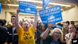 Supporters celebrate news that Democrat Ralph Northam won the gubernatorial election, at the Northam for Governor election night party at George Mason University in Fairfax, Va., Nov. 7, 2017. 