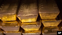 Twenty four karat gold bars are seen at the United States West Point Mint facility in West Point, New York, June 5, 2013. 