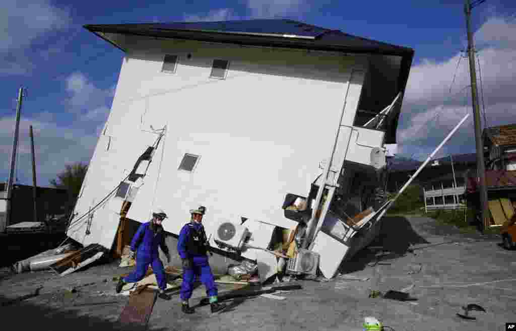 Rescuers check the damage area caused by earthquakes in Minamiaso, Kumamoto prefecture, April 17, 2016.