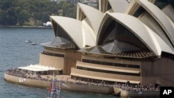 A loan boat decorated with national flags sails past the Opera House in Sydney, Australia (File Photo)