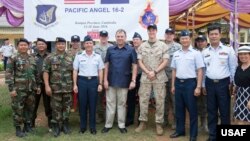 U.S. Ambassador to Cambodia, William Heidt, poses for a photo with members of Pacific Angel Team.