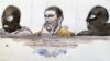 A court sketch made on Jan. 10, 2019 shows Mehdi Nemmouche,center, accused of the terrorist attack at the Jewish Museum in Brussels in 2014, during his trial at the Brussels Justice Palace. 