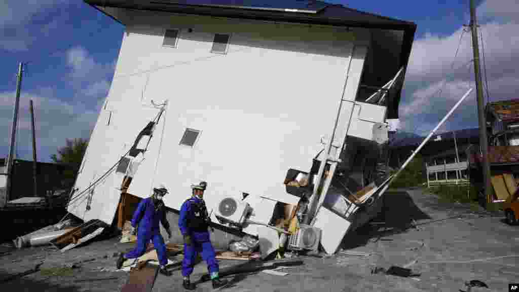 Rescuers check the damage area caused by earthquakes in Minamiaso, Kumamoto prefecture, April 17, 2016.