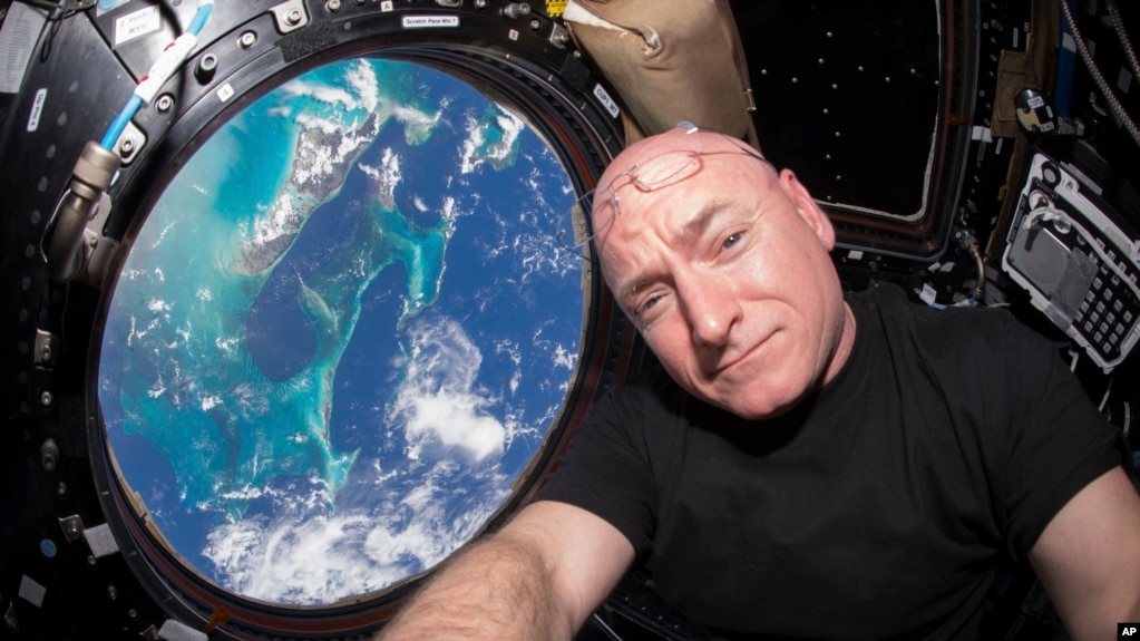 In this July 12, 2015 photo, Astronaut Scott Kelly takes a photo of himself inside the Cupola, a special module of the International Space Station that provides 360-degree viewing of the Earth and the station.