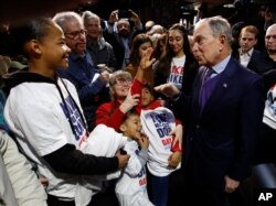 Democratic presidential candidate and former New York City Mayor Michael Bloomberg, right, talks with supporters during a campaign stop in Sacramento, Calif., Feb. 3, 2020.