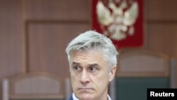 FILE - U.S. investor and founder of the Baring Vostok private equity group Michael Calvey, who is under house arrest on suspicion of fraud, attends a court hearing in Moscow, Russia, Aug. 15, 2019.