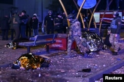 Police officers inspect the bodies of residents killed at a public transportation stop during Russian air and missile strikes in Zaporizhzhia, Ukraine, on Jan. 8, 2025.