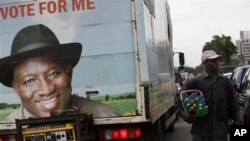 A truck with an election campaign banner depicting Nigeria's incumbent President Goodluck Jonathan, in Lagos, Nigeria, Wednesday, April 13, 2011