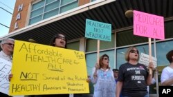 Protesters wait for the arrival of Senate Majority Leader Mitch McConnell, R-Ky., at the Hardin County Lincoln Day Dinner, June 30, 2017, in Elizabethtown, Ky.