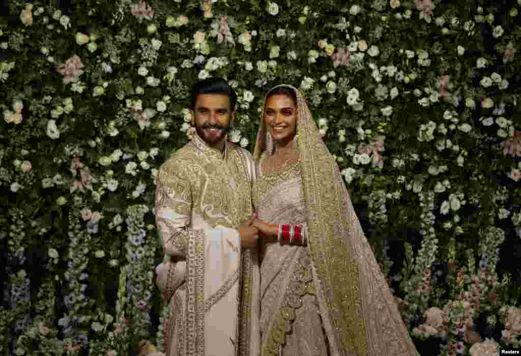 Bollywood actors Ranveer Singh and Deepika Padukone pose during a photo-op at their wedding reception in Mumbai, India.