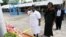 FILE - Liberian Minister of Justice Christine Tah (center right) observes a moment of silence with a senior female police officer at a 2011 ceremony for fallen peacekeepers.