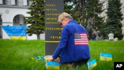 FILE - Ryan Wesley Routh pays tribute to foreign citizens killed during Russia-Ukraine war in a central square in Kyiv, Ukraine, Apr. 30, 2022.