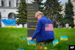 FILE - Ryan Wesley Routh pays tribute to foreign citizens killed during Russia-Ukraine war in a central square in Kyiv, Ukraine, Apr. 30, 2022.