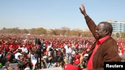 FILE: Leader of Zimbabwe's opposition party Movement For Democratic Change (MDC) Morgan Tsvangirai greets supporters at a rally in Harare, July 29, 2013. 