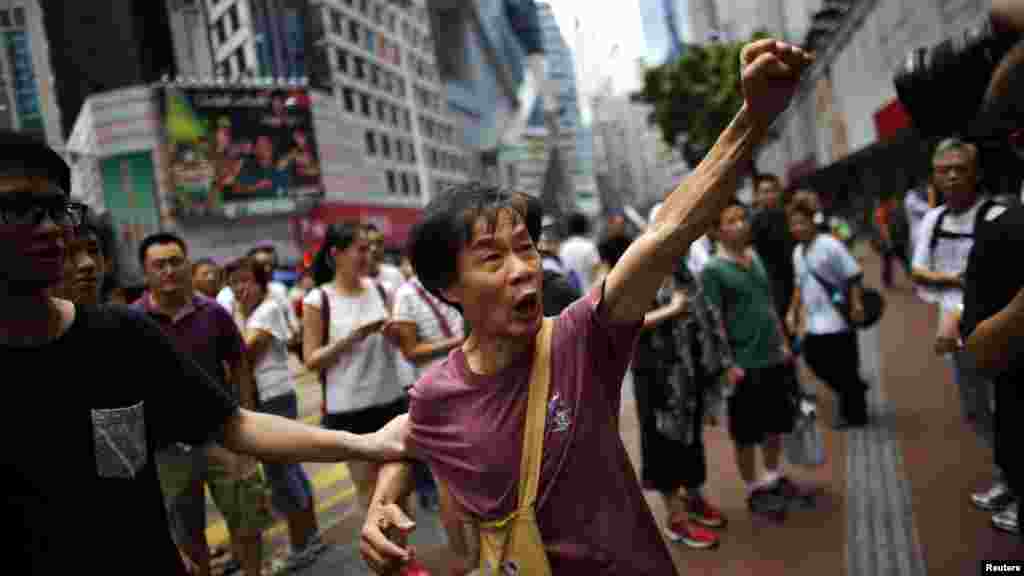 A pro-democracy protester argues with a pro-Beijing demonstrator (not pictured) as people block areas around the government headquarters building in Hong Kong, October 1, 2014.