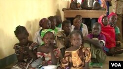 FILE - Children are seen sitting on the floor of their school in Fotokol, Cameroon. (M.E. Kinzeka/VOA)
