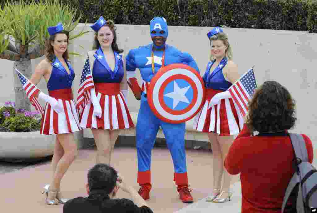 Dwight Boyd, dressed as Captain America, poses for photographers on the third day of Comic-Con at the San Diego Convention Center, July 14, 2012, in San Diego.
