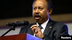 FILE - Sudan's Prime Minister in the transitional government Abdallah Hamdok speaks at the Friendship Hall in Khartoum, Sudan, December 25, 2019.