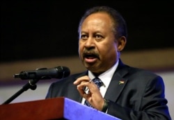 Sudan's Prime Minister in the transitional government Abdalla Hamdok addresses people as they celebrate the first anniversary of the start of the uprising that toppled long-time ruler Omar al-Bashir, at the Friendship Hall in Khartoum, Dec 25, 2019.