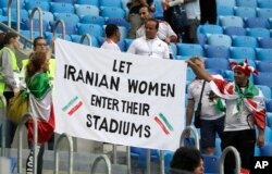 FILE - People supporting Iranian women hold a banner at the stands during the group B match between Morocco and Iran at the 2018 soccer World Cup in the St. Petersburg Stadium in St. Petersburg, Russia, June 15, 2018.