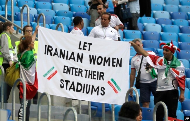 FILE - People supporting Iranian women hold a banner at the stands during the group B match between Morocco and Iran at the 2018 soccer World Cup in the St. Petersburg Stadium in St. Petersburg, Russia, June 15, 2018.