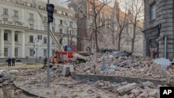 A view of debris on a street from nearby buildings, hundreds of meters from Ukraine's Presidential Office, after a Russian drone attack in Kyiv, Ukraine, Jan. 1 2025.