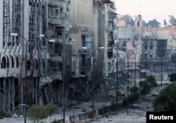 Destroyed buildings are seen on a deserted street in the besieged area of Homs, Syria, July 4, 2013.