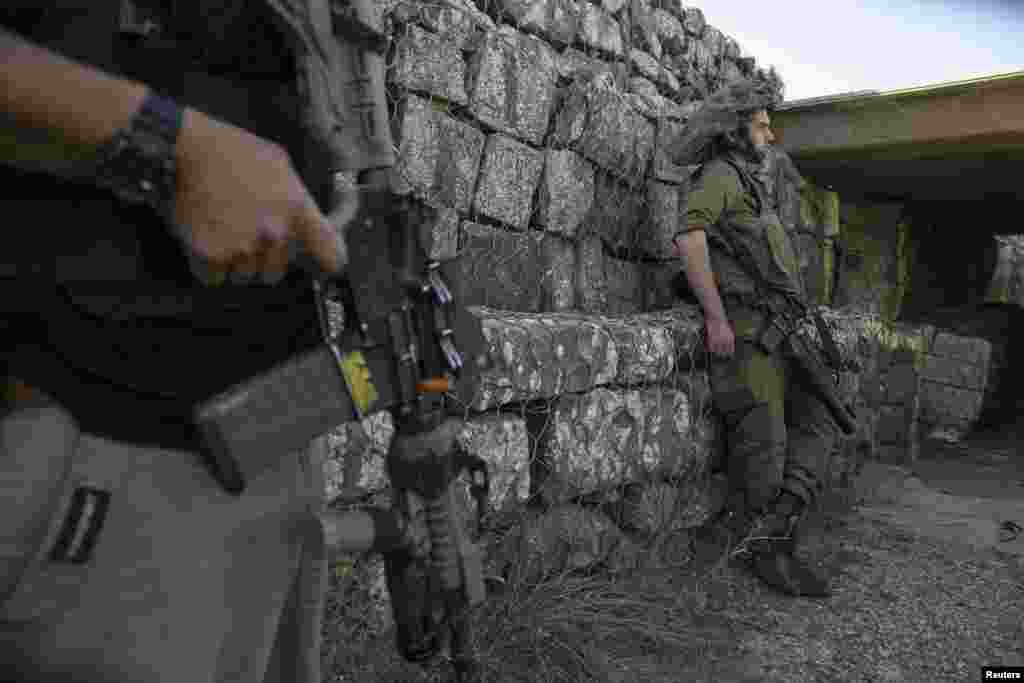 An Israeli soldier stands at a military outpost in the Israeli-occupied Golan Heights, near the border fence with Syria, Sept. 1, 2014.