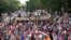 Supporters listen to a speech by Muhammad Tahirul Qadri, Sufi cleric and leader of political party Pakistan Awami Tehreek (PAT), during a demonstration outside his residence in Lahore, August 10, 2014.