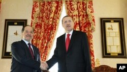 Turkish Prime Minister Tayyip Erdogan (R) and Kurdistan Region President Masoud Barzani shake hands before their meeting in Istanbul, April 19, 2012.