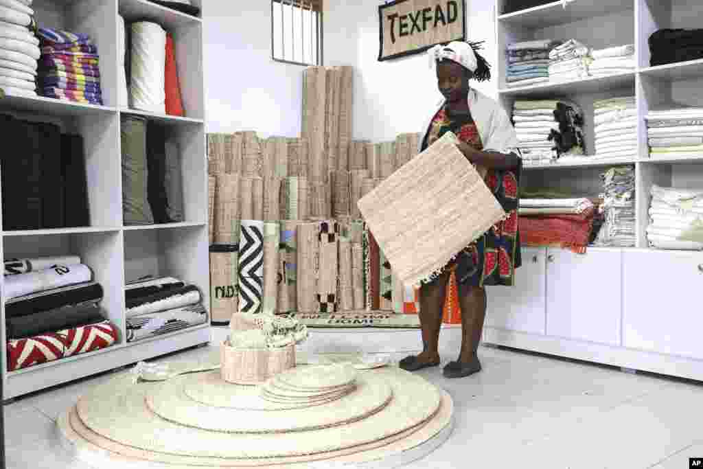 Beatrice Namawejje, marketing and sales personnel for TEXFAD, displays banana fiber products, at a showroom in Kira, Wakiso District, Uganda, Sept. 20, 2023.&nbsp;